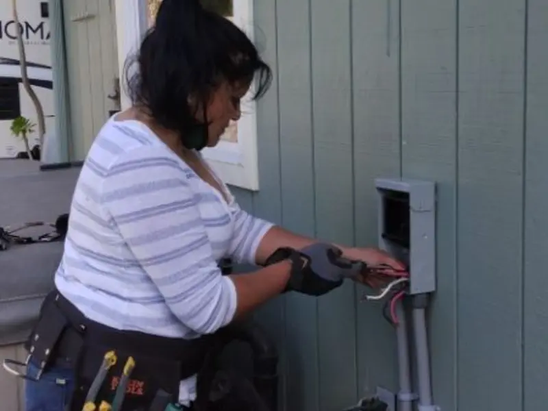 Licensed electrician wiring an exterior subpanel in Otsego